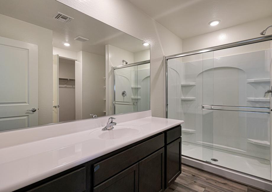 The master bath has a spacious, glass-enclosed shower.