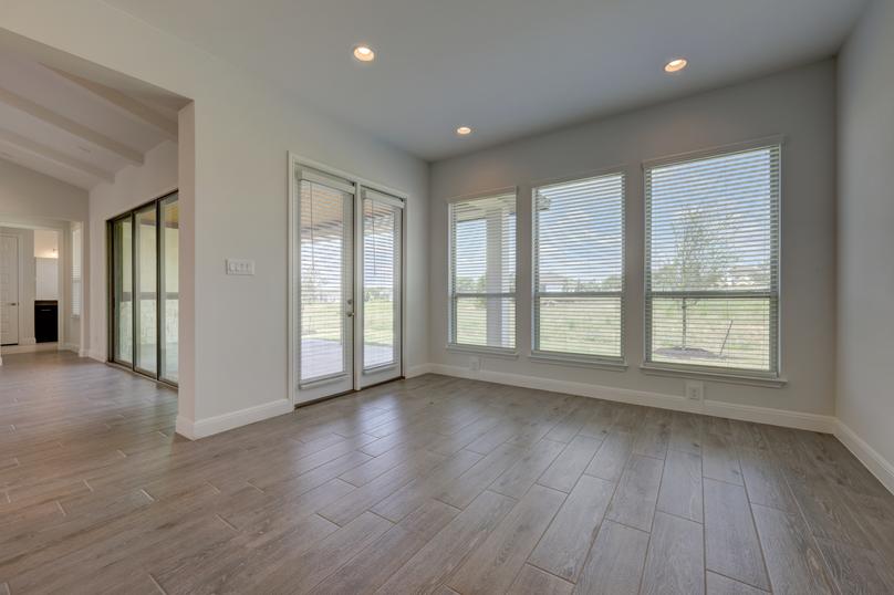 Breakfast area with large windows, creating a bright open space that peers into the back yard.