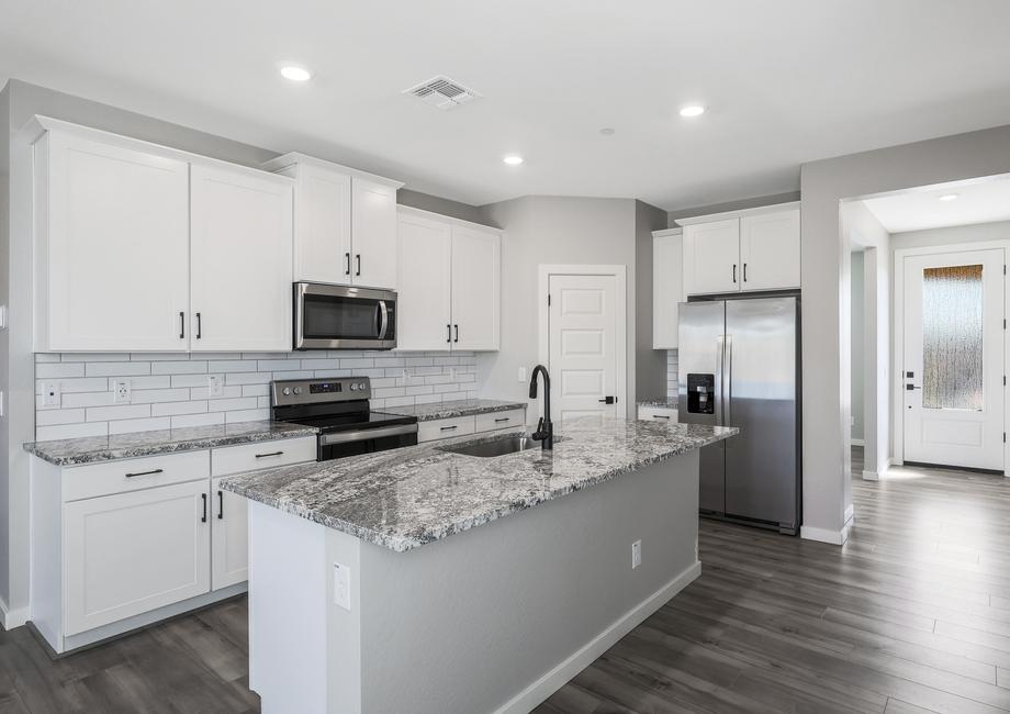 Chef-ready kitchen with white cabinets and stainless steel appliances.