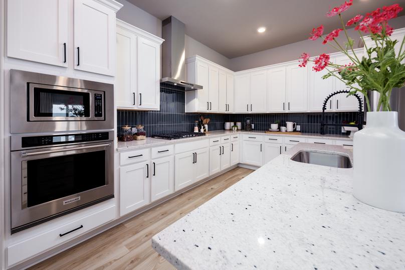 Enjoy the gorgeous granite countertops and modern tile backsplash.