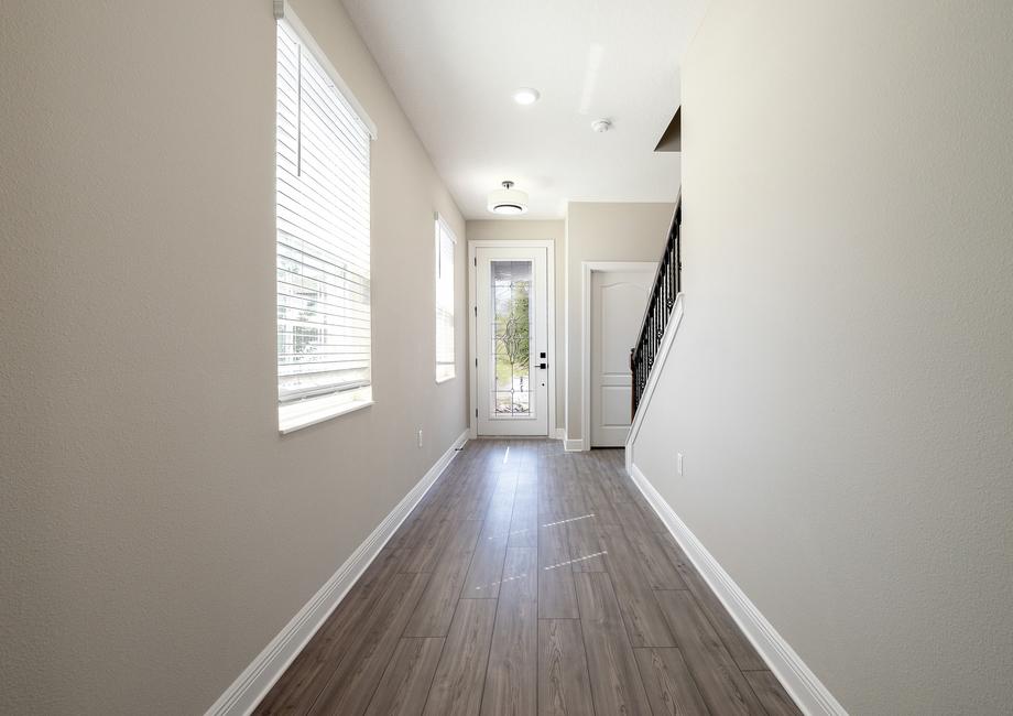 A beautiful long entry hallway that leads to family room.