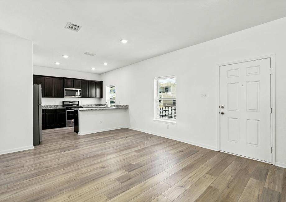 Open-concept layout with the upgraded kitchen overlooking the dining area.