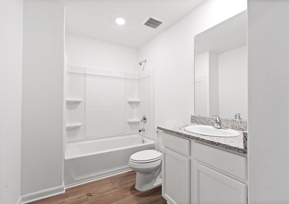 Secondary bathroom with a dual shower and tub.