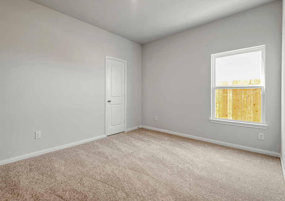 Secondary bedroom with its own closet and carpet flooring