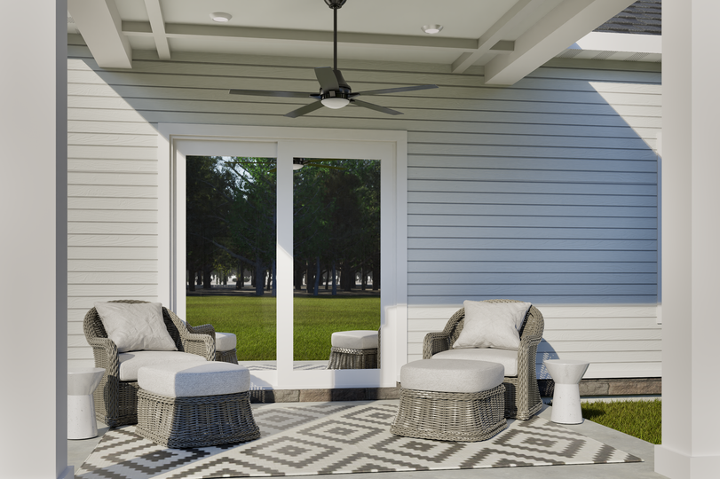 Covered back patio of the Birch model home with outdoor seating area.
