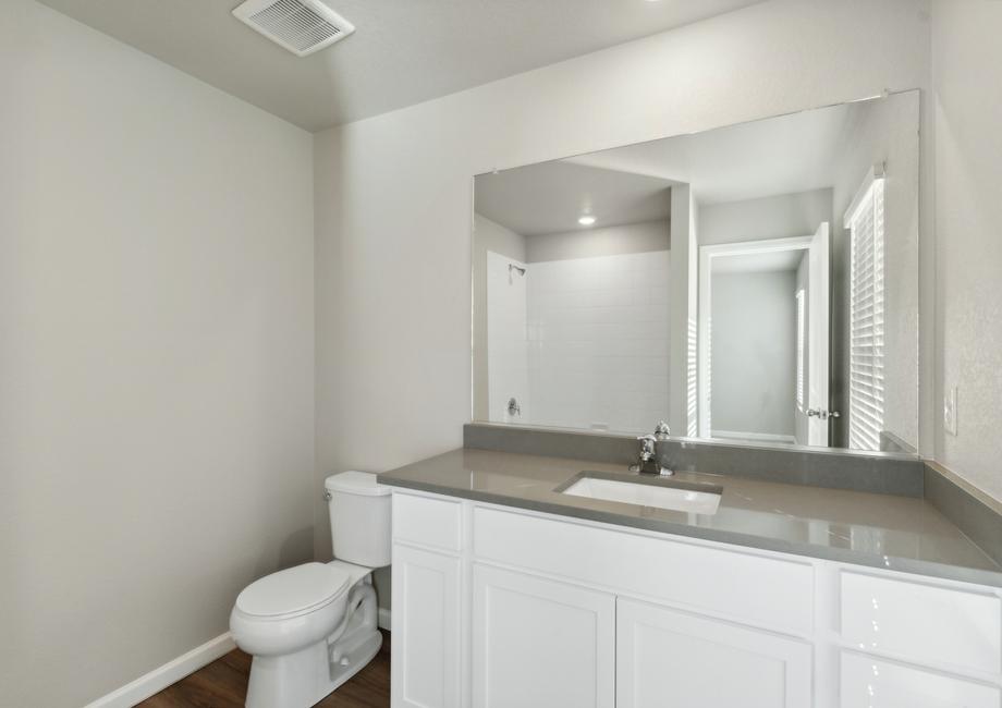The master bathroom has a tub/shower combo and large vanity.