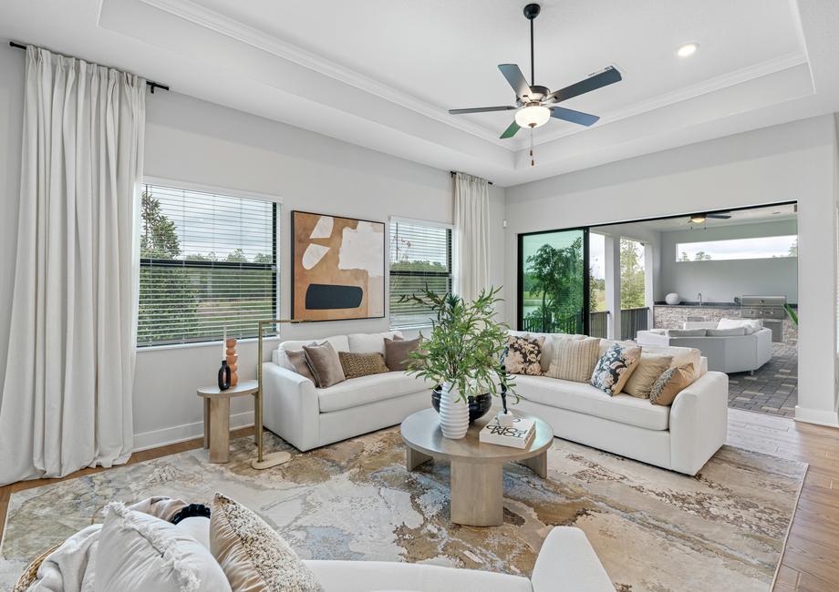 The living room offers access to the outdoor living area with a kitchen.