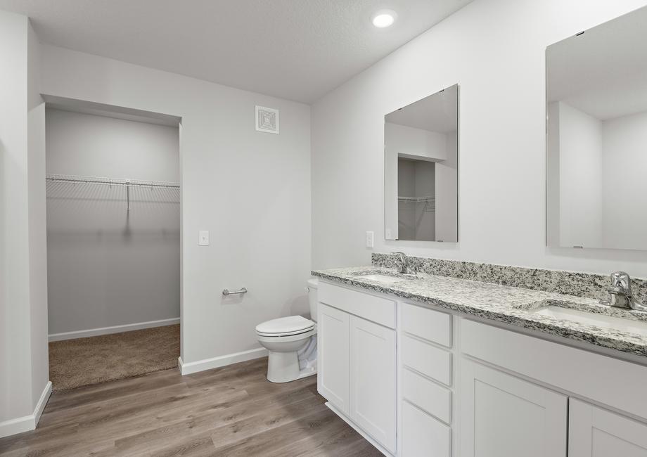 The master bathroom has a dual sink vanity.