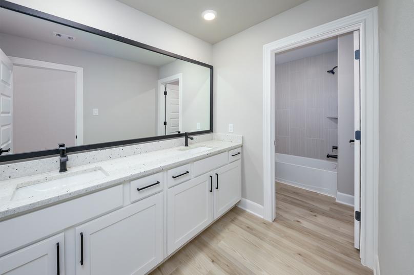 The secondary bedroom includes a large granite vanity.
