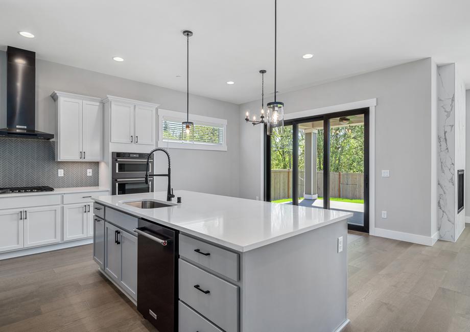 The chef-ready kitchen overlooks the dining space that has a large sliding door.