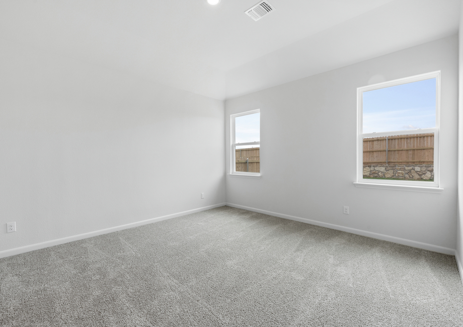 The master bedroom is spacious and has large windows that let in great, natural light.