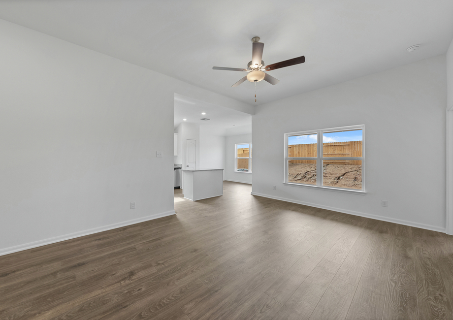 The spacious family room with light wood luxury vinyl flooring