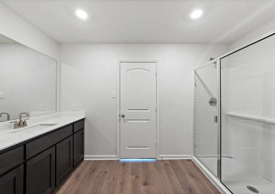 The master bathroom has a glass, walk-in shower.