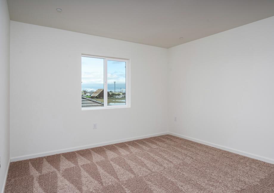 The master bedroom is spacious with a large window.