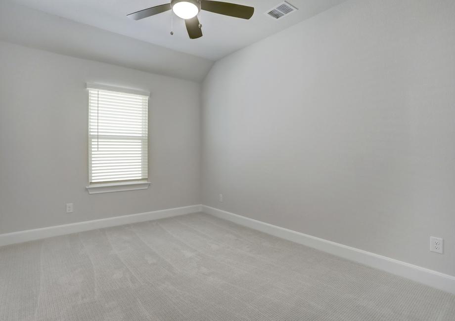Guest bedroom with carpet and a ceiling fan.
