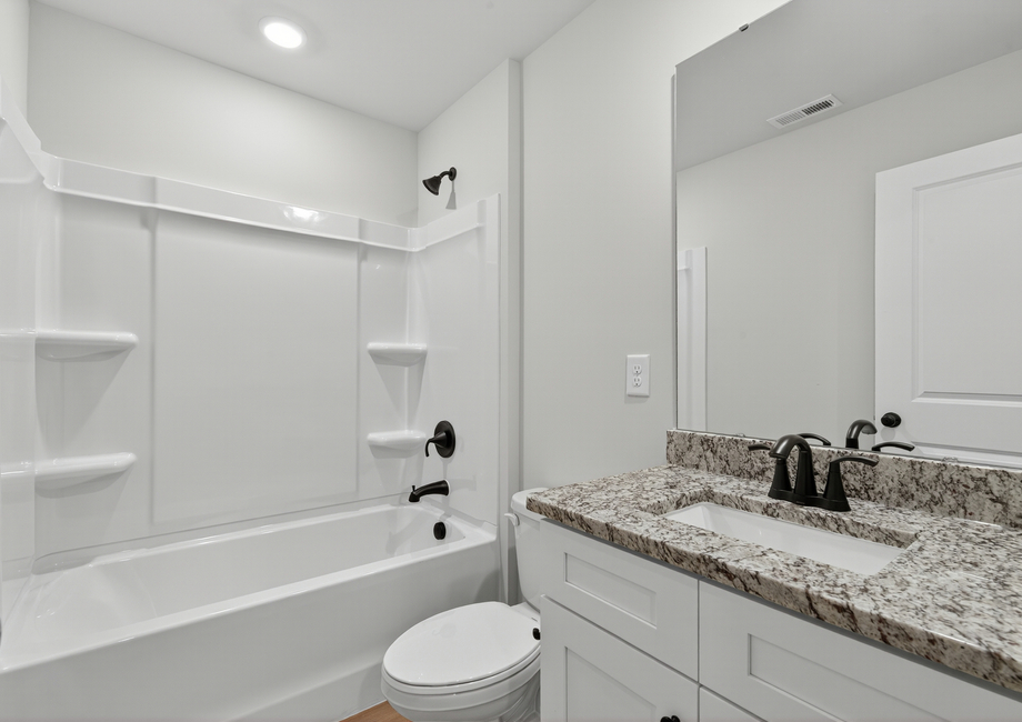 The secondary bathroom has a large soaking tub.