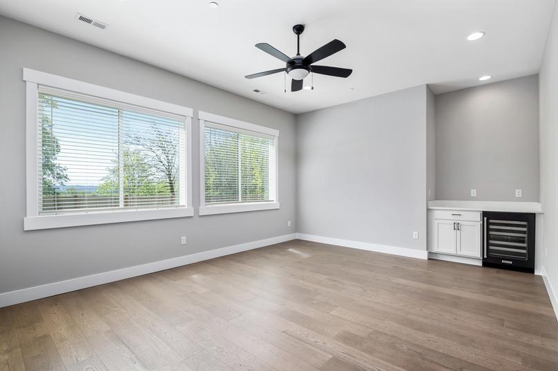 Large windows, beautiful floors and a wine fridge are all located in the living area.