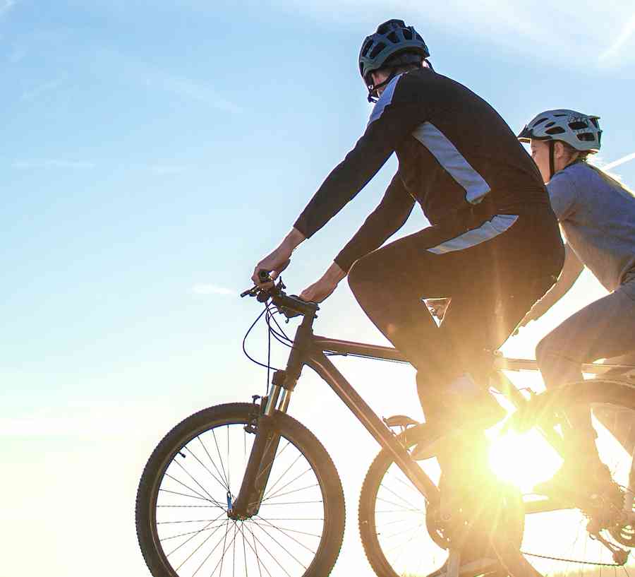 People on bikes at sunset.