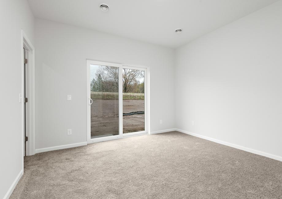 The master bedroom has access to the back yard.