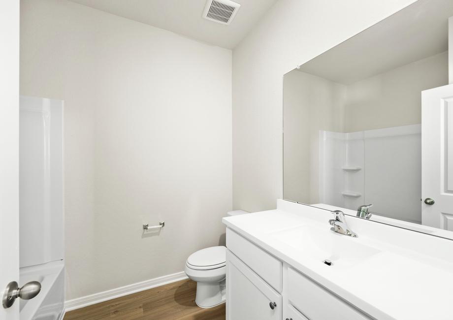 This secondary bathroom has a tub/shower combination.