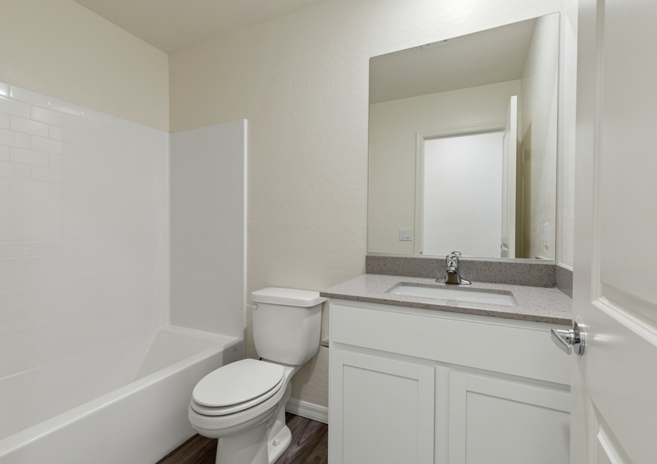 The secondary bathroom of the Aspen has plenty of counterspace and a shower-tub combo.