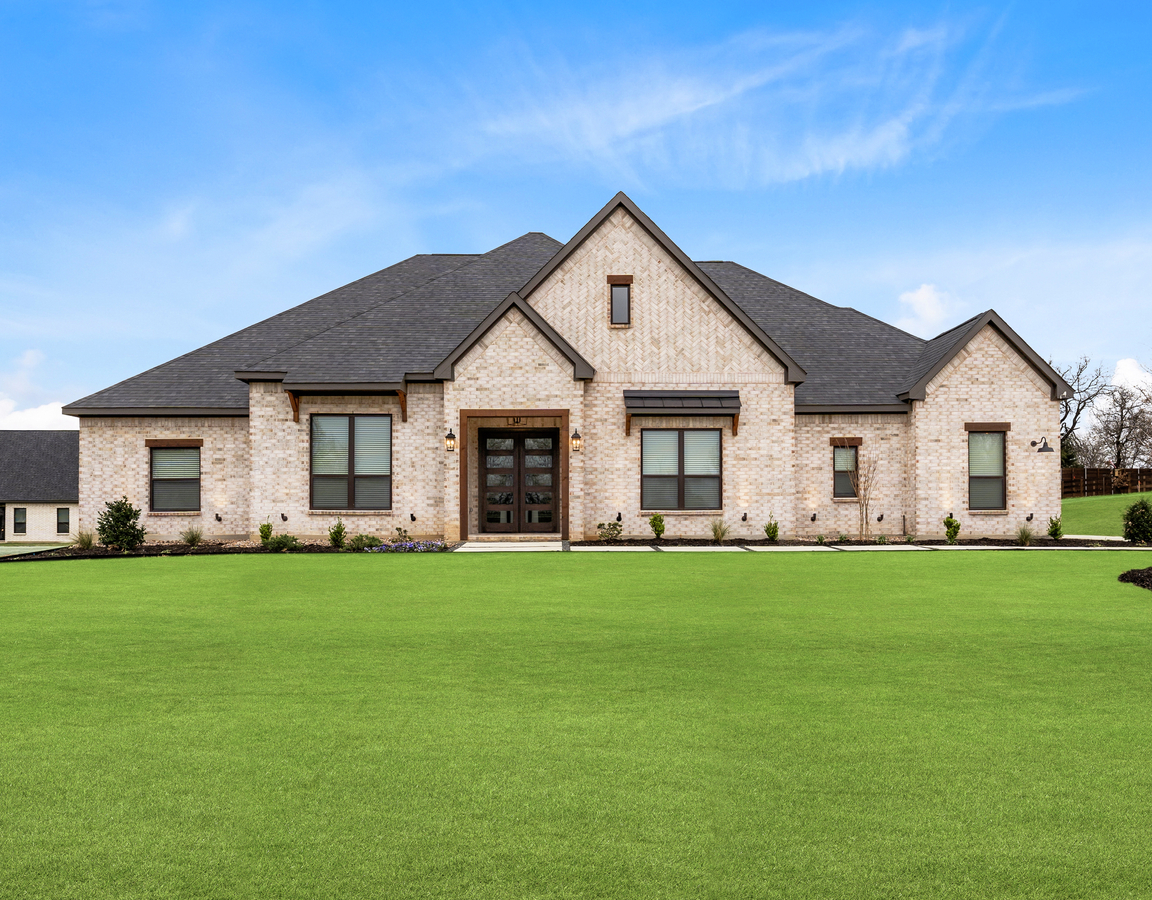 The Stratton II is a beautiful, one-story brick home with wood accents.