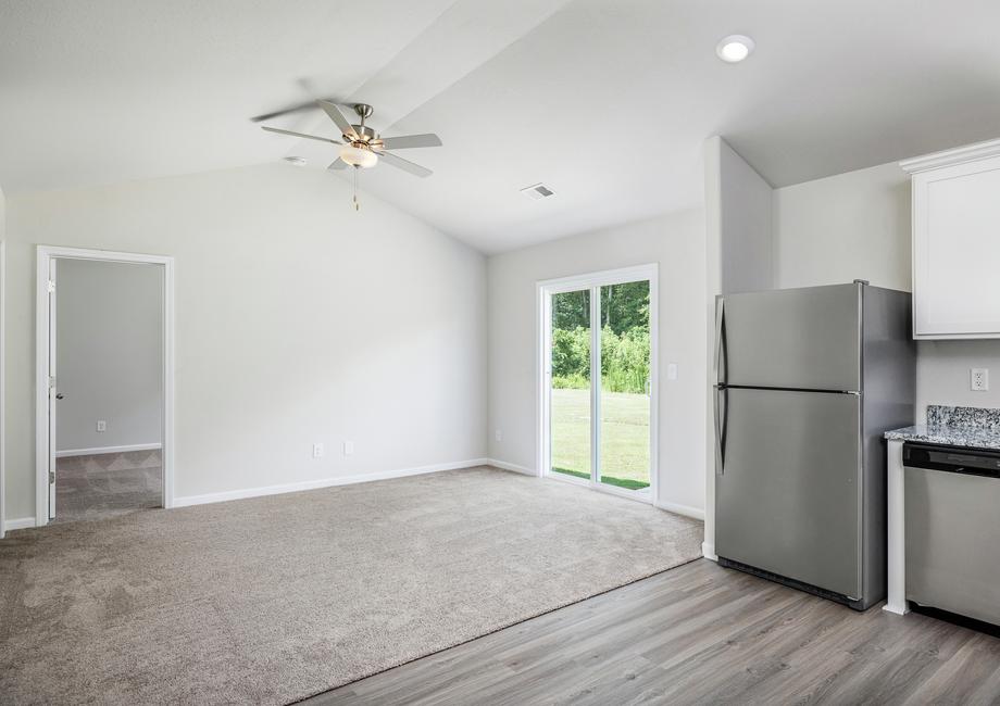 View if the living room with carpet from the kitchen.