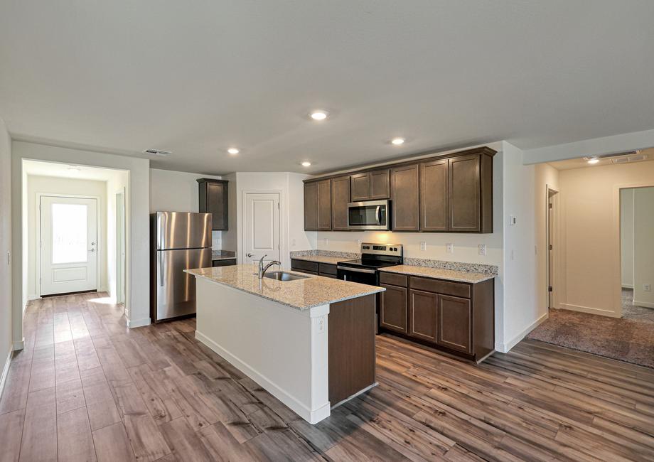 Enjoy stunning granite countertops and designer wood cabinetry in this kitchen.