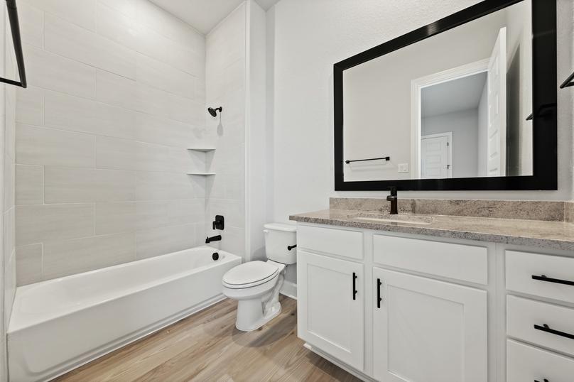 The secondary bathrooms are spacious and have fantastic storage under the vanity.