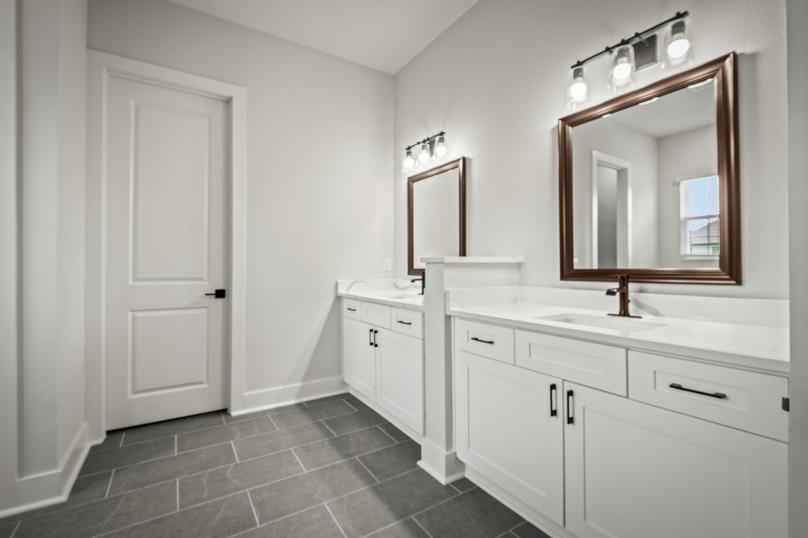 The master bathroom has a dual-sink vanity.