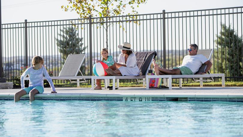 Family relaxing at the neighborhood pool.