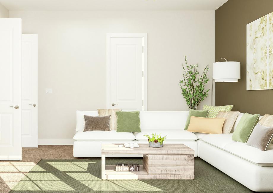 Rendering of sitting area showing a media
  cabinet and tv left, a large white sectional couch and coffee table along a
  green accent wall on right with beige carpet flooring throughout.