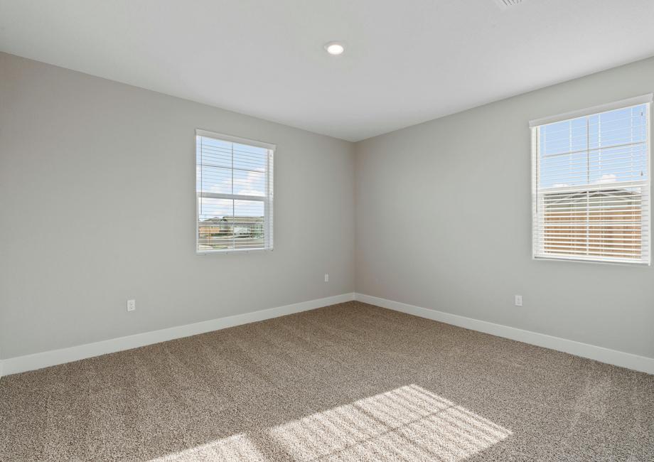 Windows let in plenty of light in the secondary bedroom.