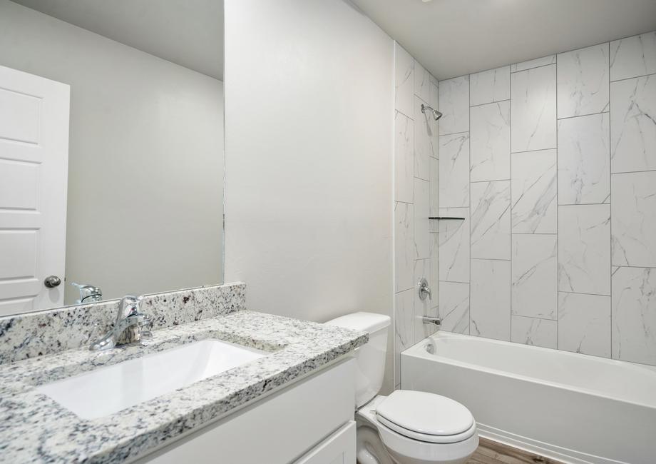 The secondary bathroom of the Kein has a large shower-tub combo.