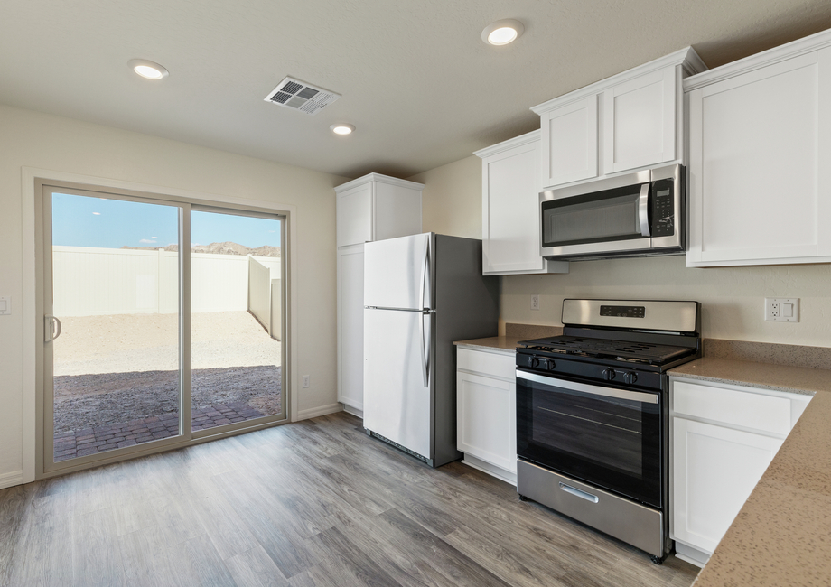 The kitchen of the Aspen has beautiful white cabinets.