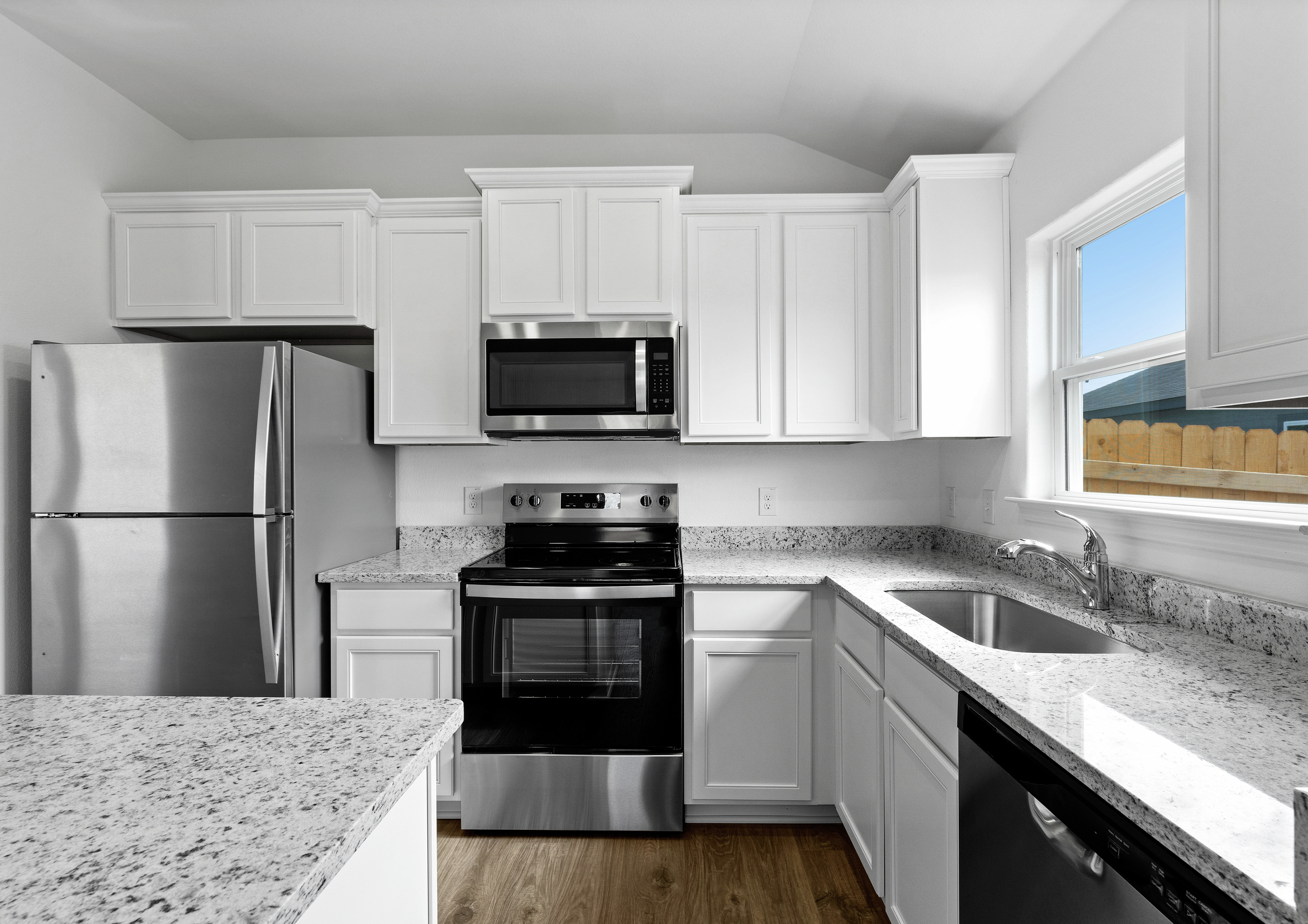 A kitchen with white cabinets and lots of counterspace