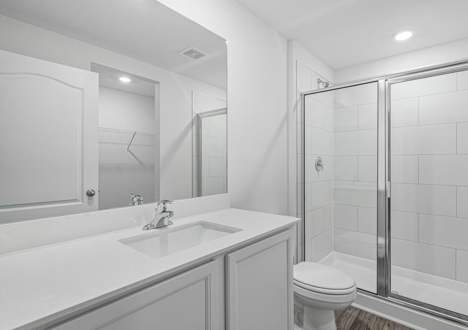 The master bathroom has a walk-in shower and spacious vanity