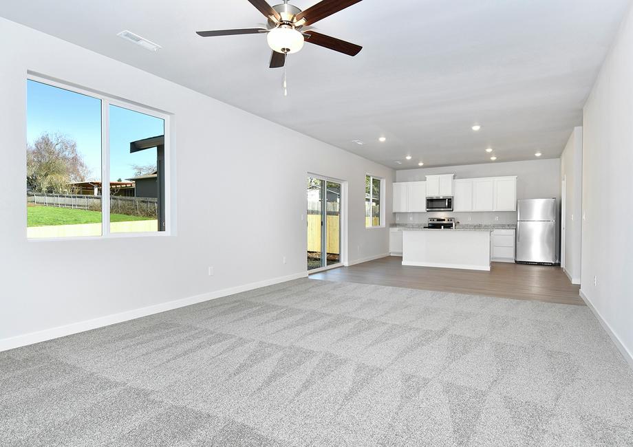 The family room is spacious and has a ceiling fan.