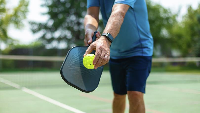 Man preparing to serve in a game of pickelball.