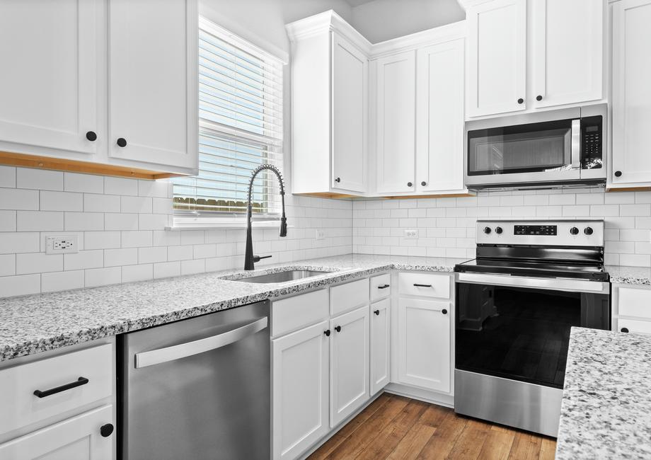 <p>Superior white upper and lower cabinets with marvelous marble countertops and a large kitchen sink. </p>