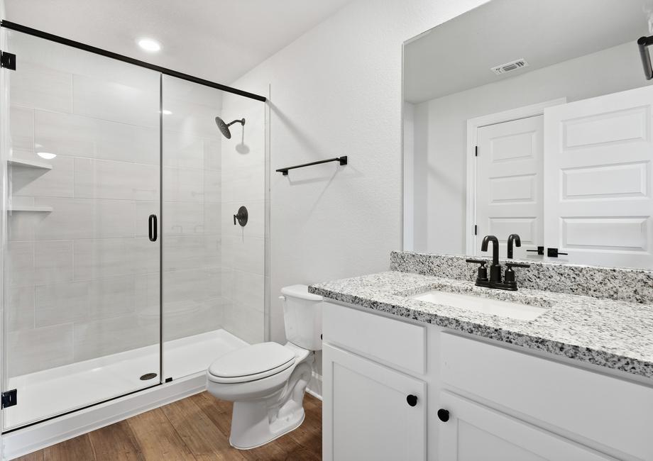 Secondary bathroom including designer feature displayed throughout the home.