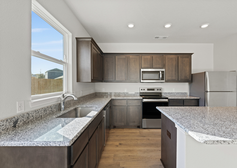 The window above the kitchen sink lets in great, natural light and backyard views.