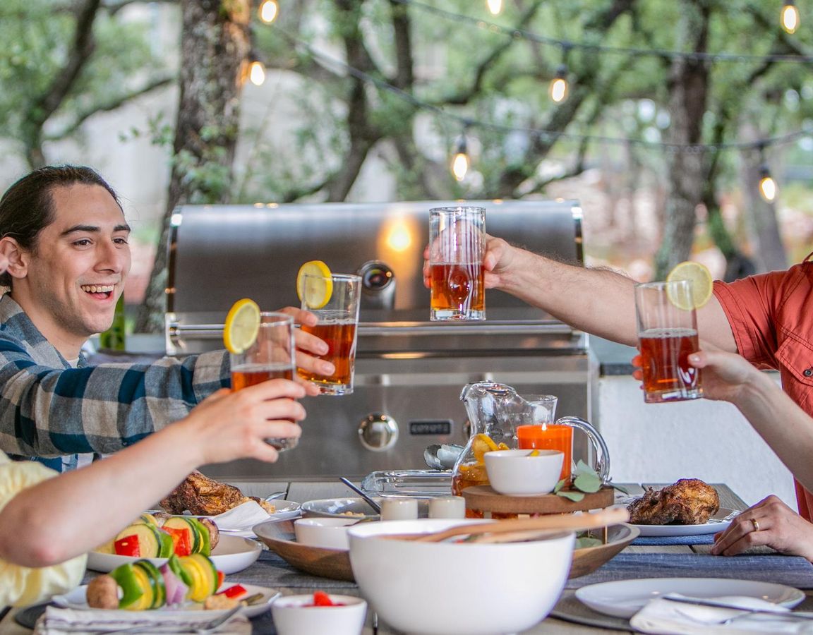 Two couples sitting down for dinner, enjoying the evening.