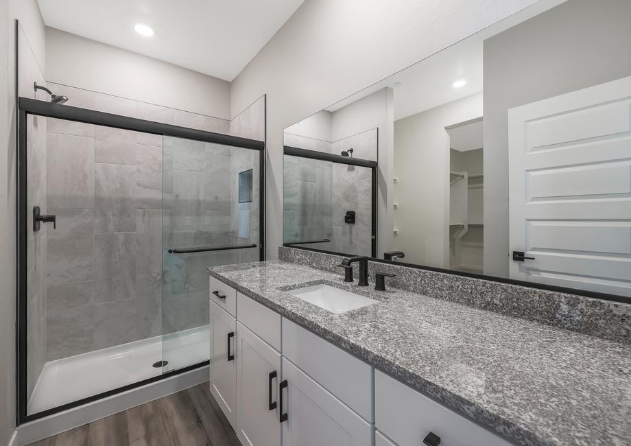 Master bathroom with a large walk-in shower and granite countertops.