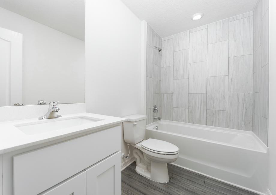 The secondary bathroom has a tub/shower combination.