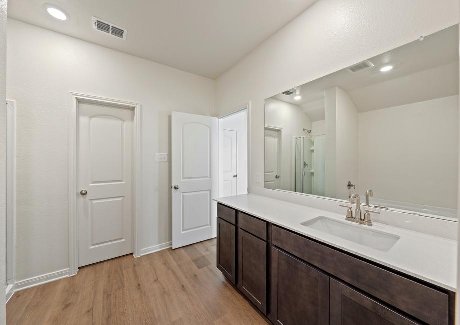 The master bathroom has a large vanity space.