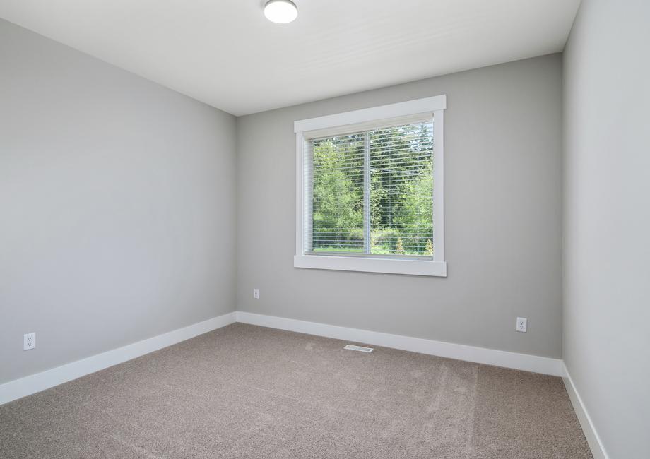 Spacious secondary bedrooms with carpet are found throughout the home.