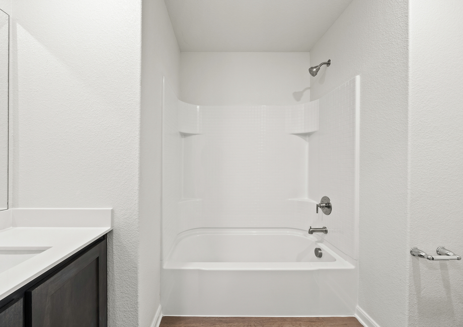 The secondary bathroom has a shower-tub combo.