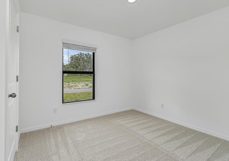 Each of the secondary bedrooms includes tan carpets, closets and bright, windows