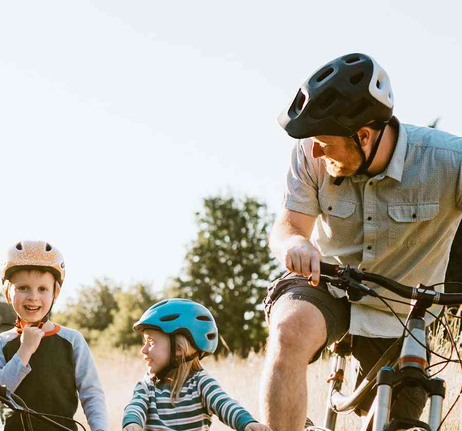 Family riding bikes on trail.